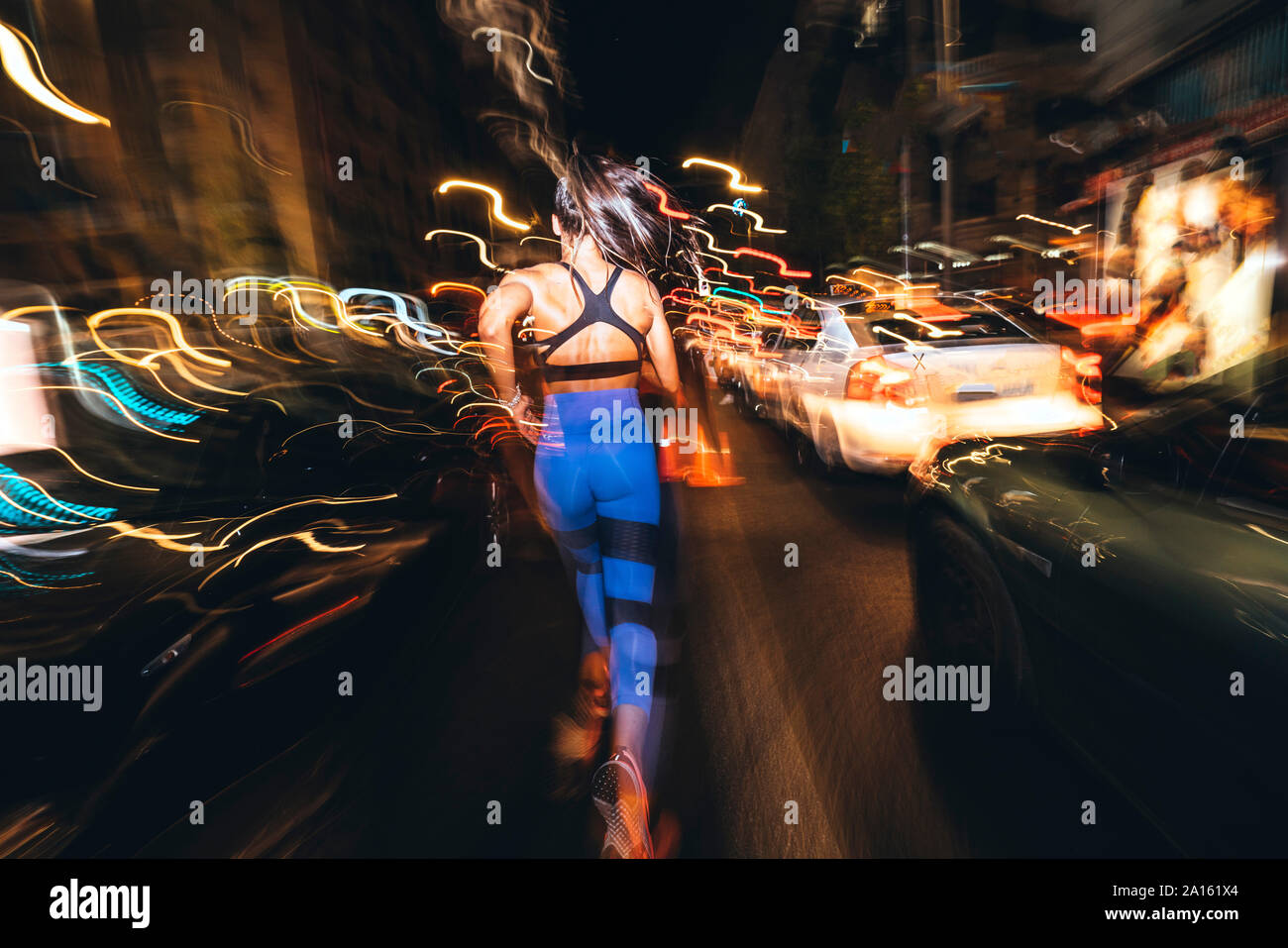 Woman street night rear view hi-res stock photography and images - Alamy