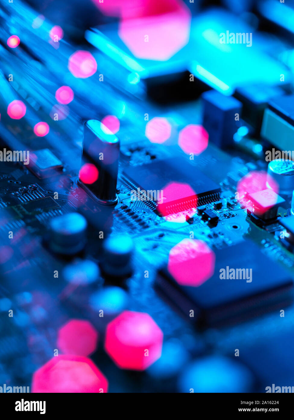 Fibre optics carrying data passing across electronic circuit board Stock Photo