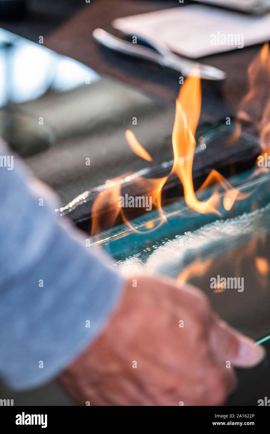Glazing, glazier during work, flame. cutting glas Stock Photo