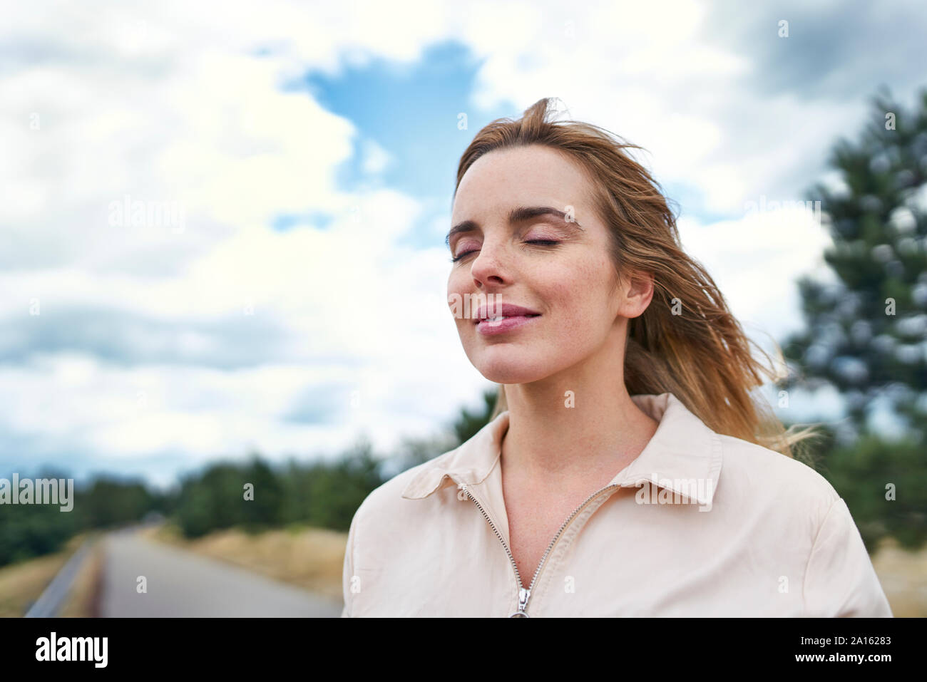 Portrait of smiling woman with closed eyes in nature Stock Photo - Alamy