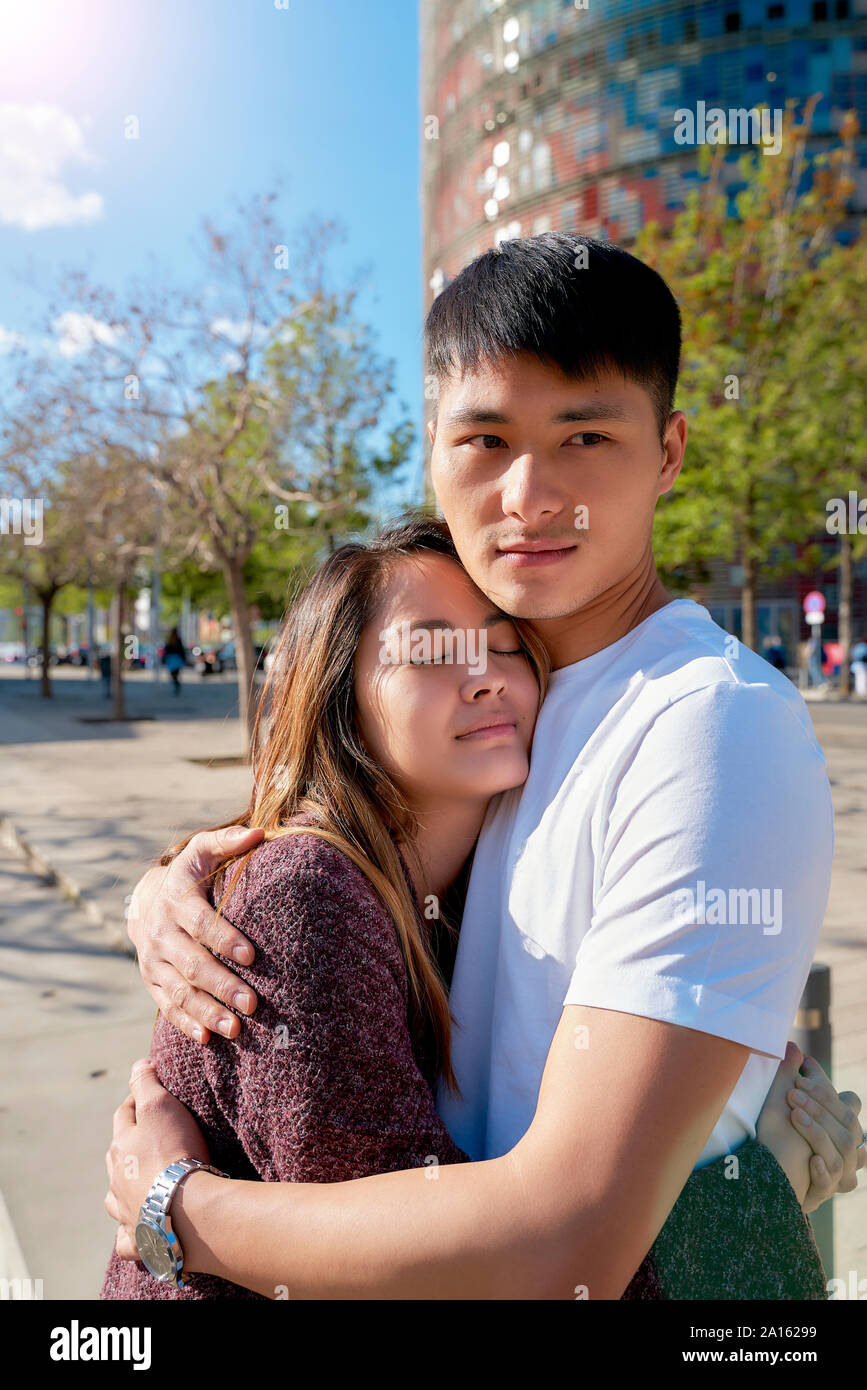 Asian couple hugging outdoors hi-res stock photography and images - Alamy