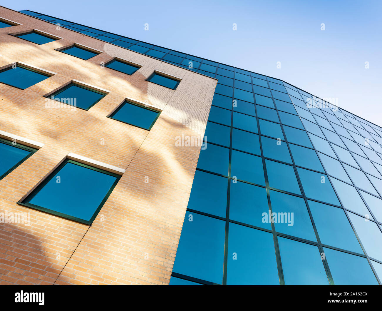facade of modern office building in glass and steel with reflections of ...