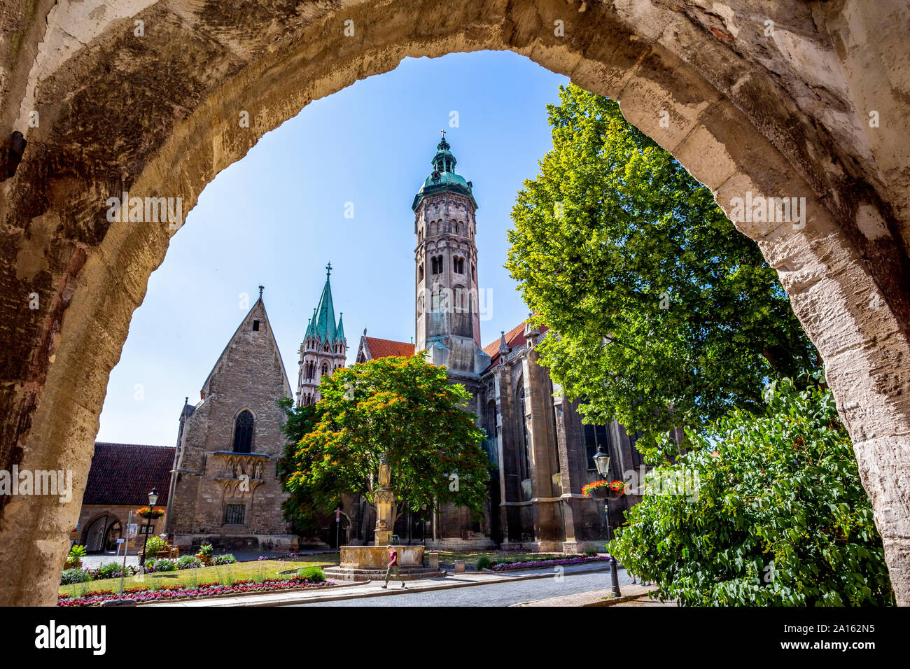 Low angle view of Naumburger Dom and trees against sky seen from archway Stock Photo