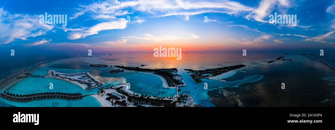 Maldives, Olhuveli island, Aerial view of resort on South Male Atoll lagoon at sunset Stock Photo