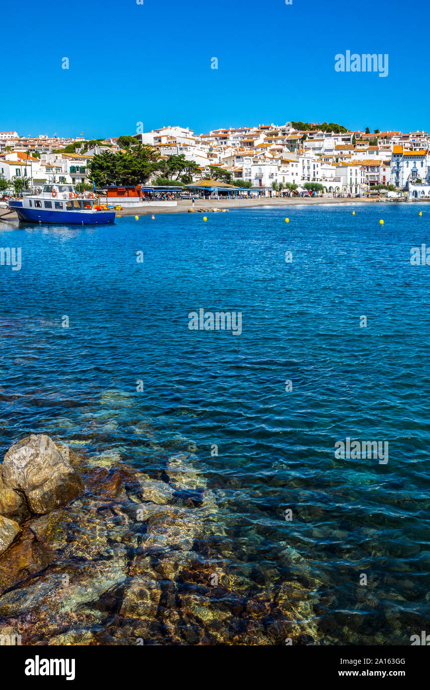 Houses in city by sea against clear blue sky Stock Photo