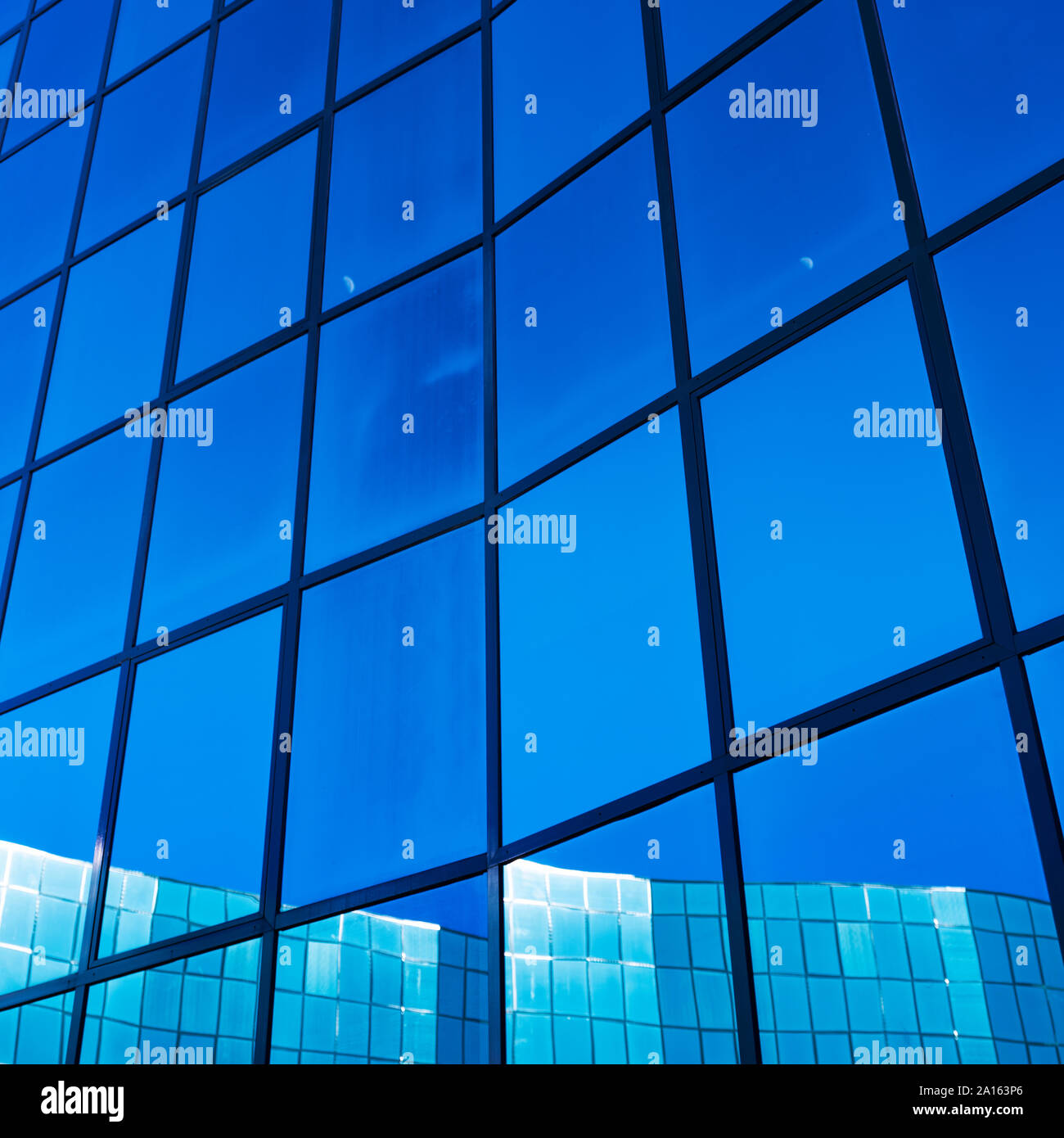 facade of modern office building in glass and steel with reflections of ...