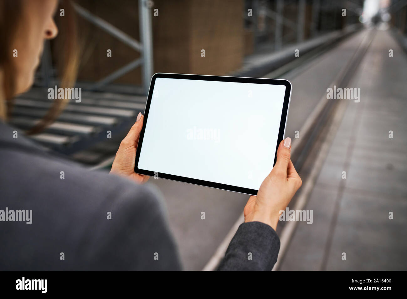 Close-up of businesswoman holding tablet in factory Stock Photo