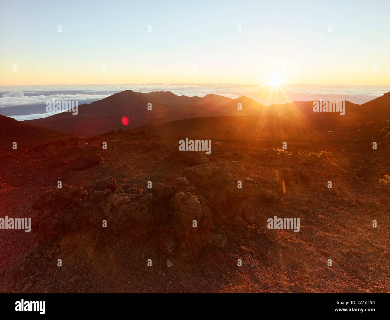 Scenic view of volcanic landscape at Haleakala National Park against sky during sunset Stock Photo