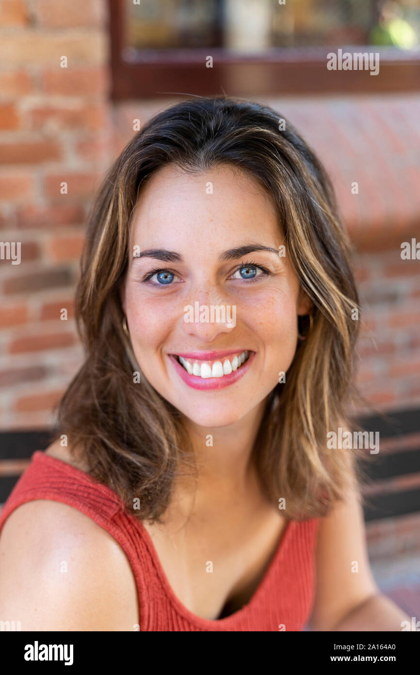 Portrait of happy young woman with blue eyes Stock Photo