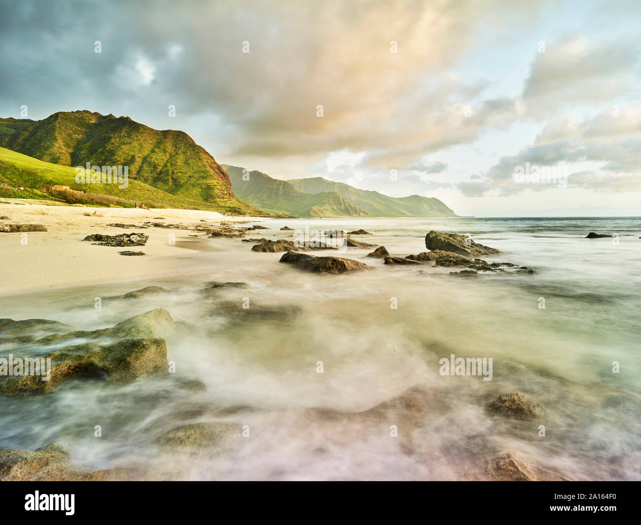 Scenic view of waves splashing on shore at beach in Ka'ena Point State Park against sky Stock Photo