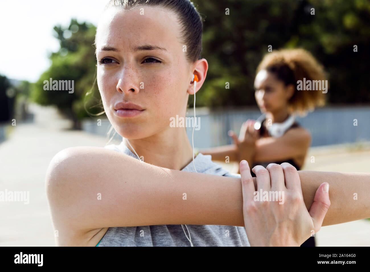 Sporty teenage girl doing stretching exercise Stock Photo