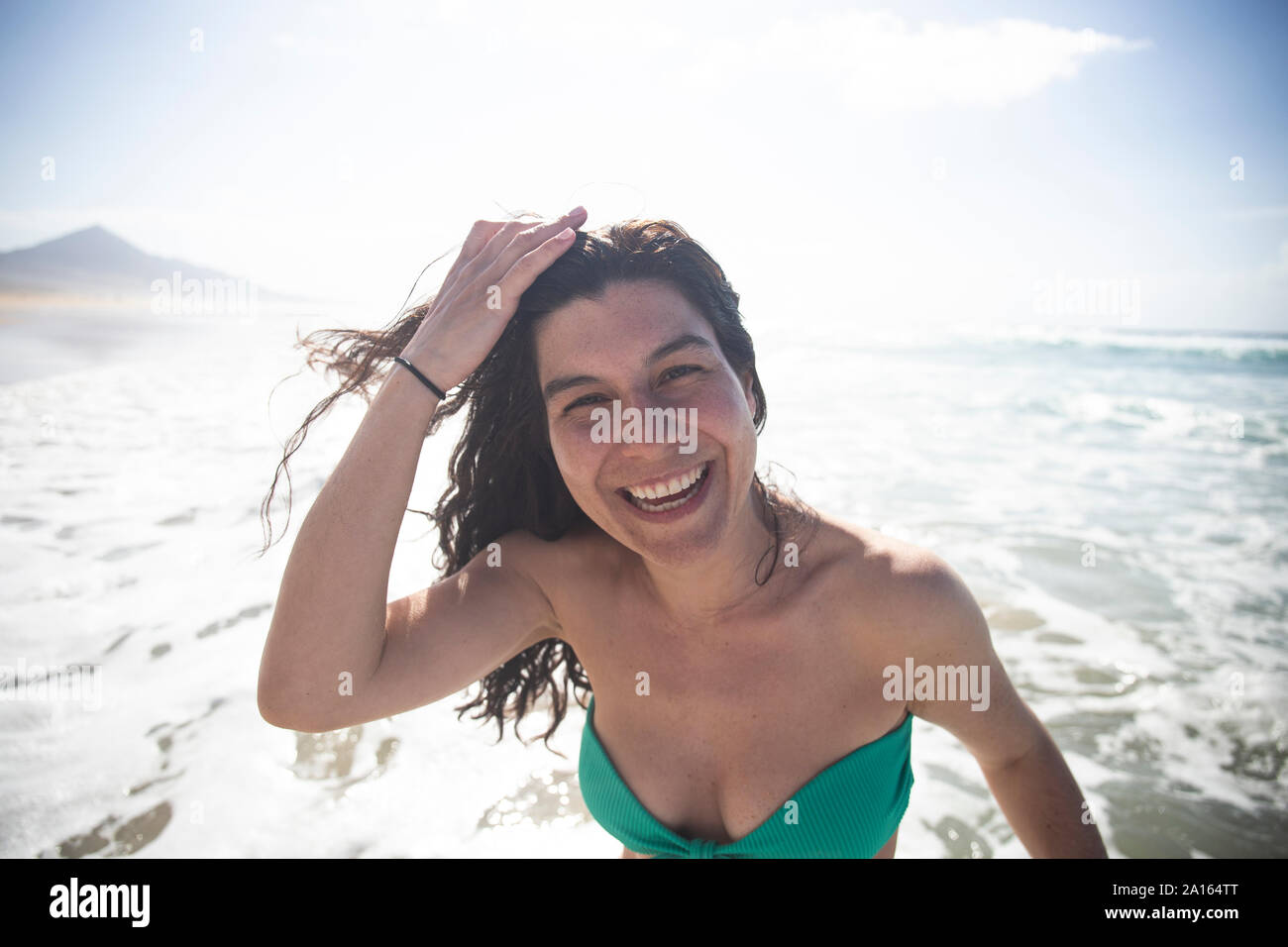 Portrait of happy woman in front of the sea, Fuerteventura, Spain Stock Photo