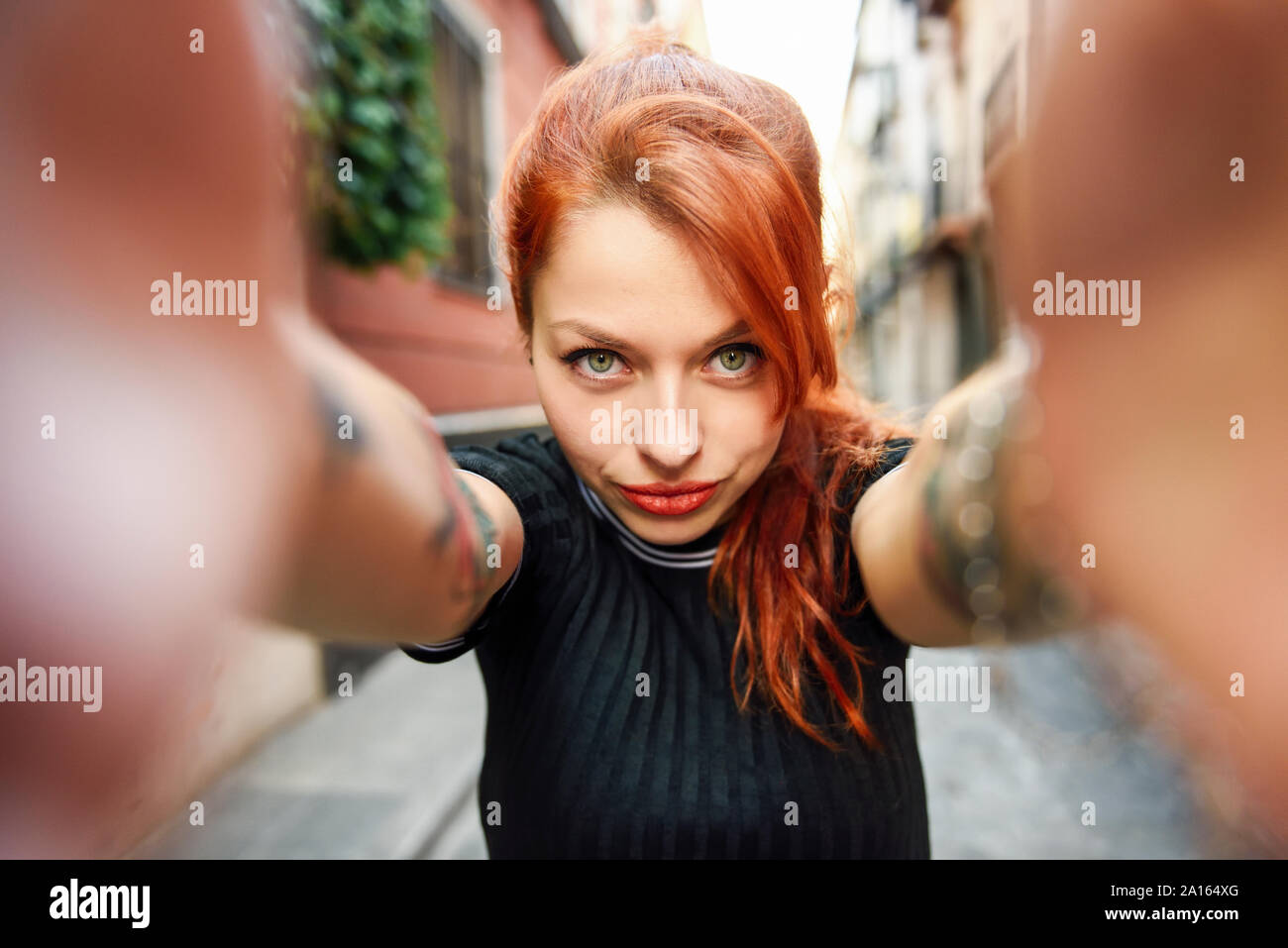 Selfie portrait of red-haired woman in the city Stock Photo