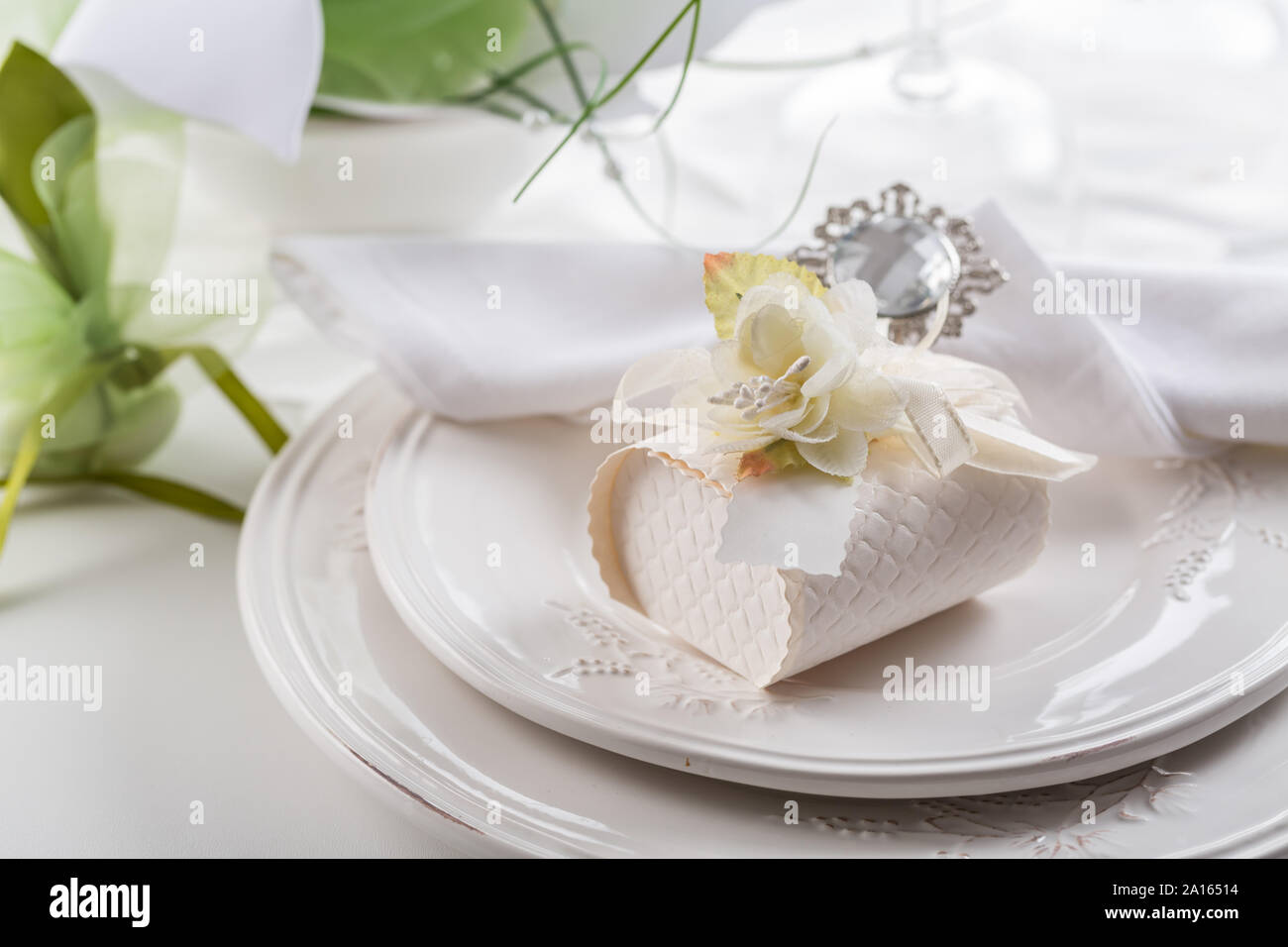 Festive table setting with small gift on plate Stock Photo