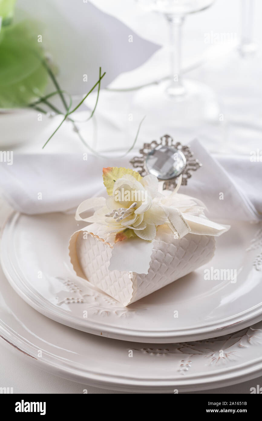 Festive table setting with small gift on plate Stock Photo