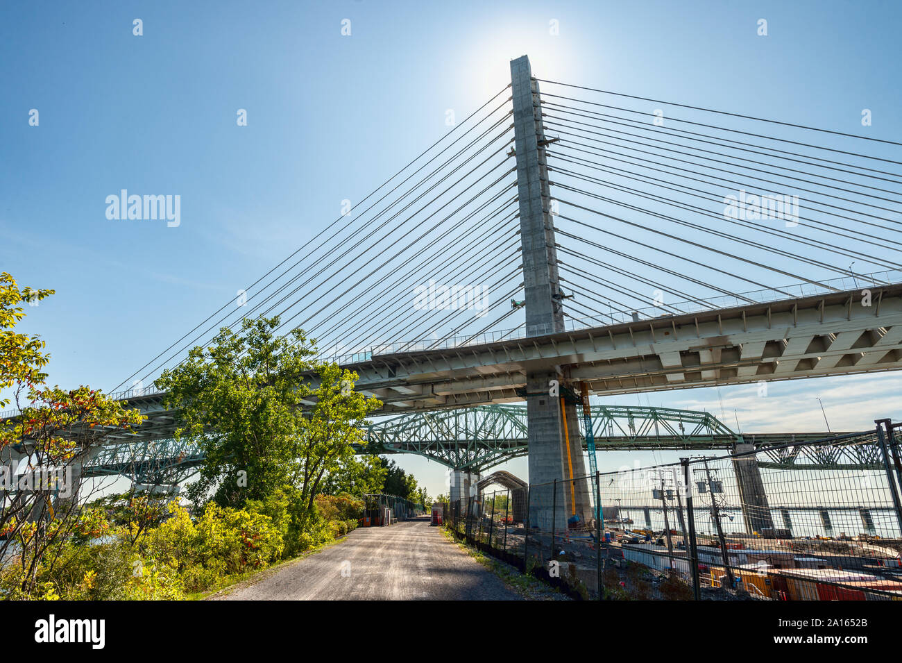 Montreal, Canada - 19 September 2019: New Champlain bridge next to Old Champlain Bridge from Petite Voie du Fleuve. Stock Photo