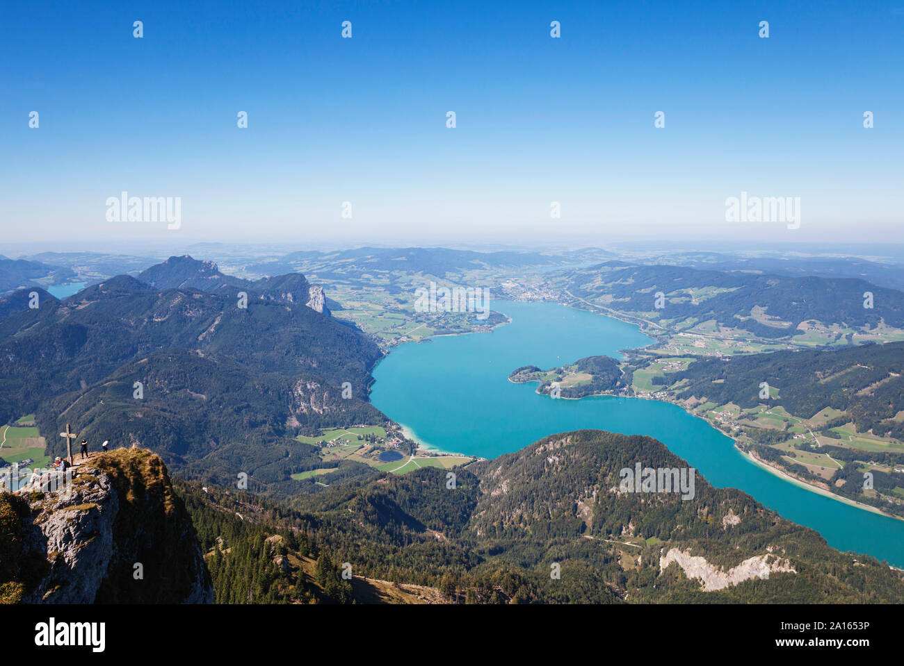 Idyllic shot of lake and mountains against blue sky Stock Photo