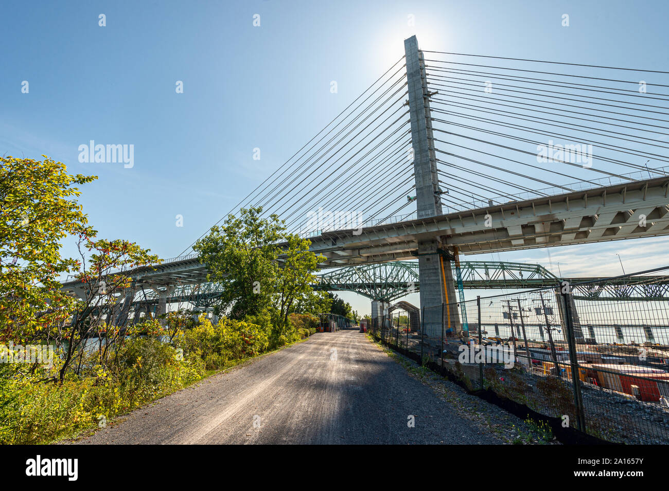 Montreal, Canada - 19 September 2019: New Champlain bridge next to Old Champlain Bridge from Petite Voie du Fleuve. Stock Photo