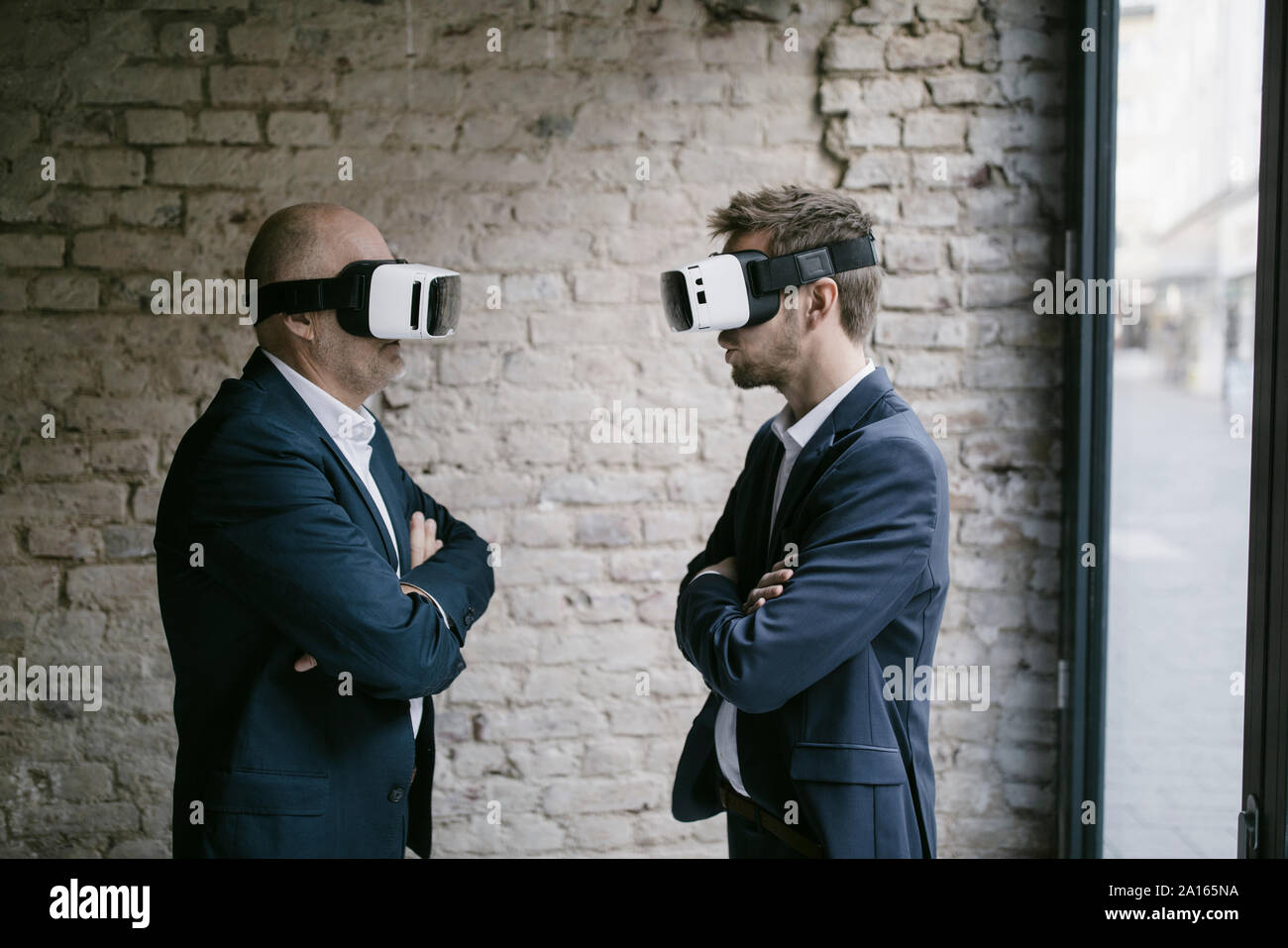 Senior and mid-adult businessman wearing VR glasses Stock Photo - Alamy