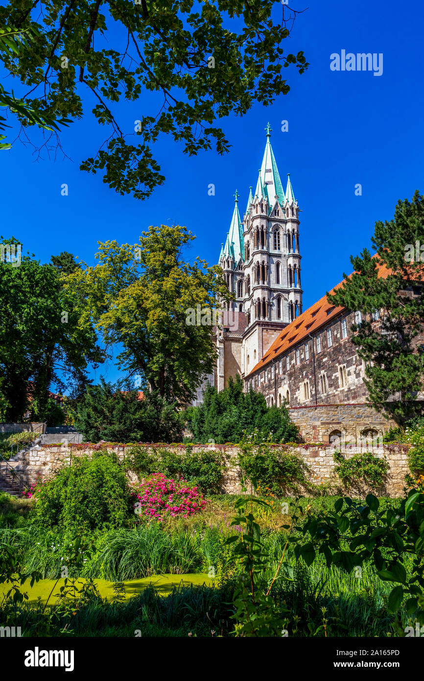 Low angle view of Naumburger Dom and trees against clear blue sky Stock Photo