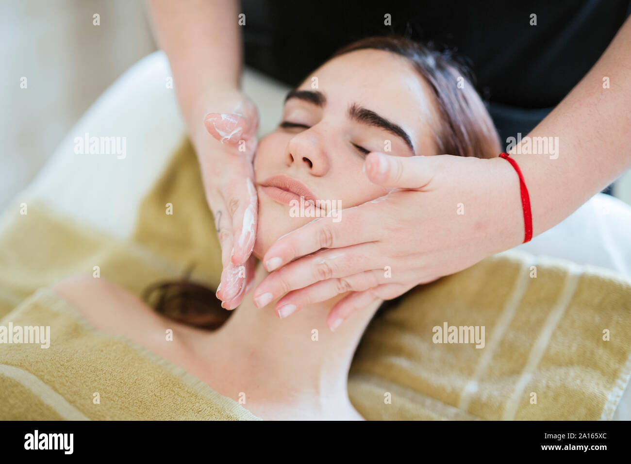 Young woman receiving facial beauty treatment in a spa Stock Photo