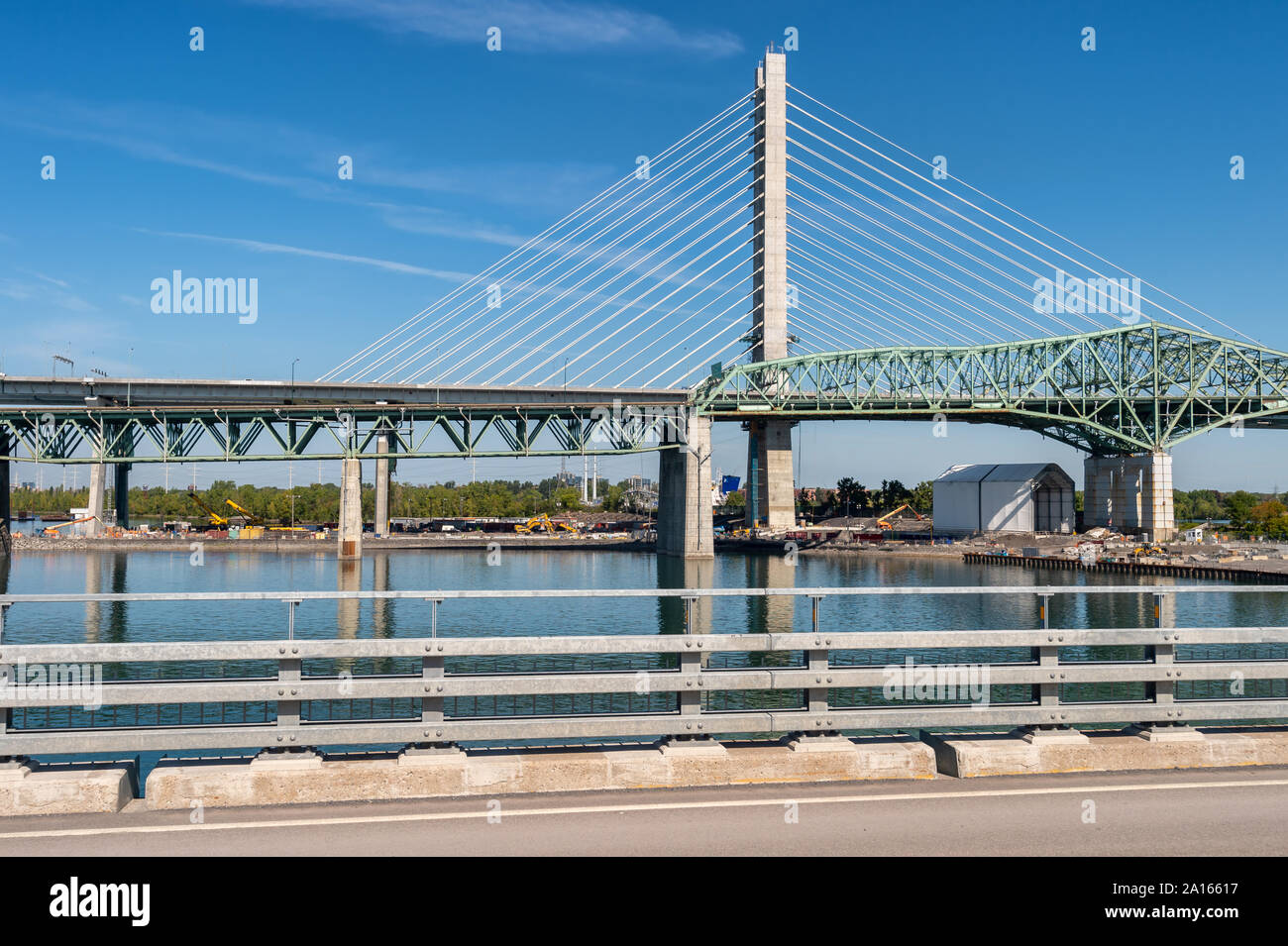 Montreal, Canada - 19 September 2019: New Champlain bridge next to Old Champlain Bridge from Estacade Bike Path. Stock Photo