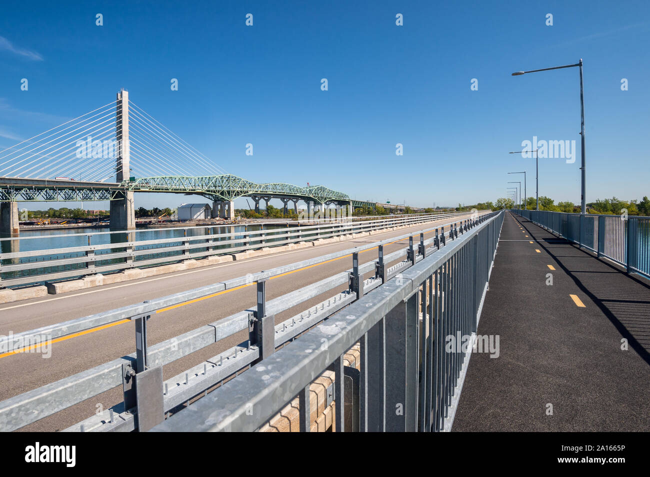 Montreal, Canada - 19 September 2019: New Champlain bridge next to Old Champlain Bridge from Estacade Bike Path. Stock Photo