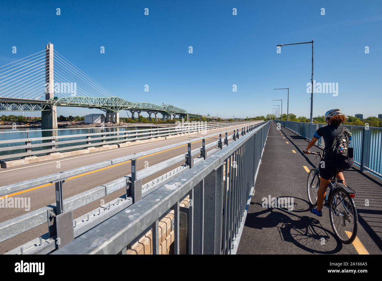 Montreal, Canada - 19 September 2019: New Champlain bridge next to Old Champlain Bridge from Estacade Bike Path. Stock Photo