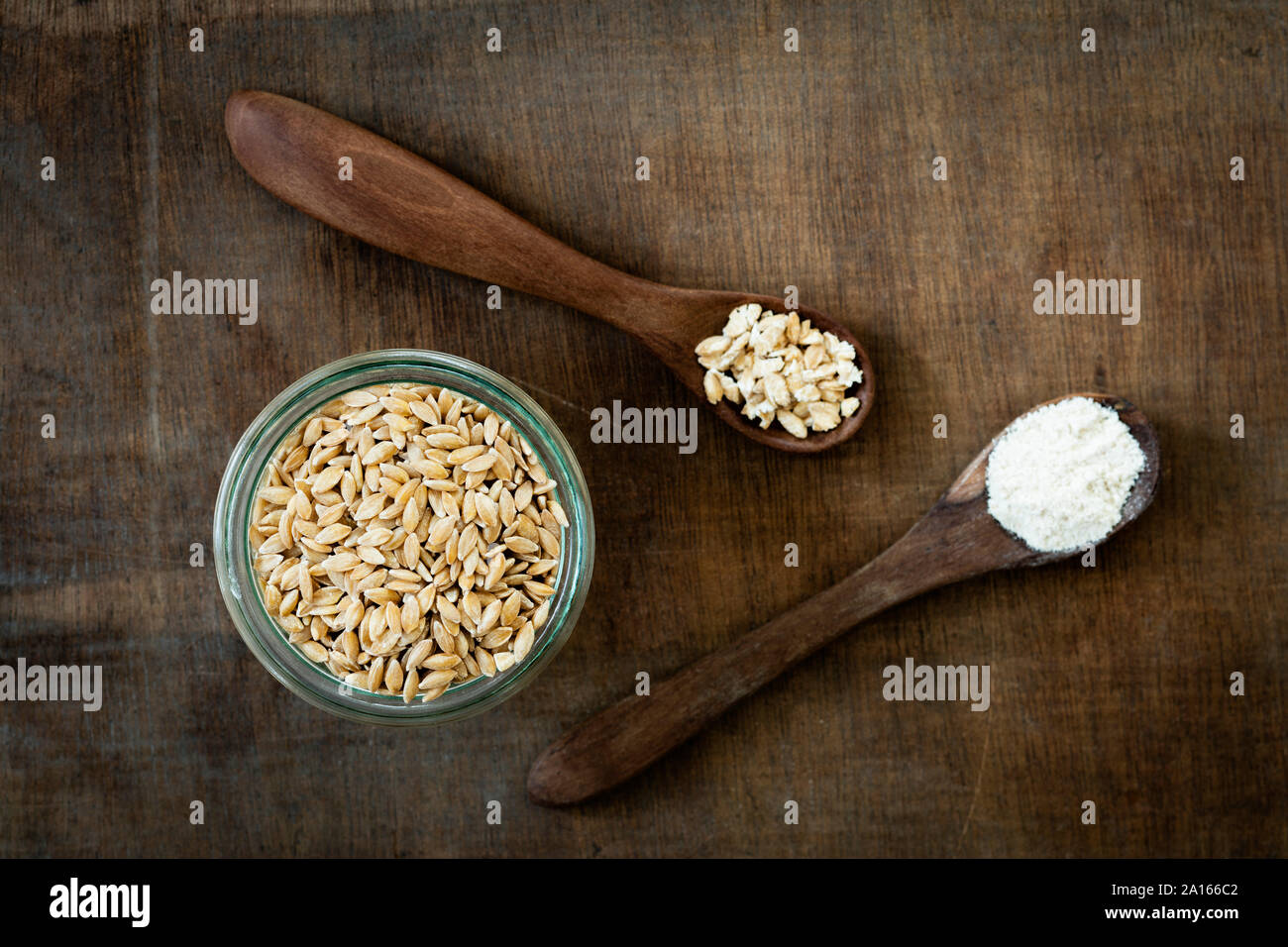 Ancient grains, Einkorn Weat in glas jar as grain, flakes and flour Stock Photo