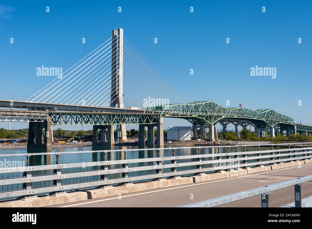 Montreal, Canada - 19 September 2019: New Champlain bridge next to Old Champlain Bridge from Estacade Bike Path. Stock Photo