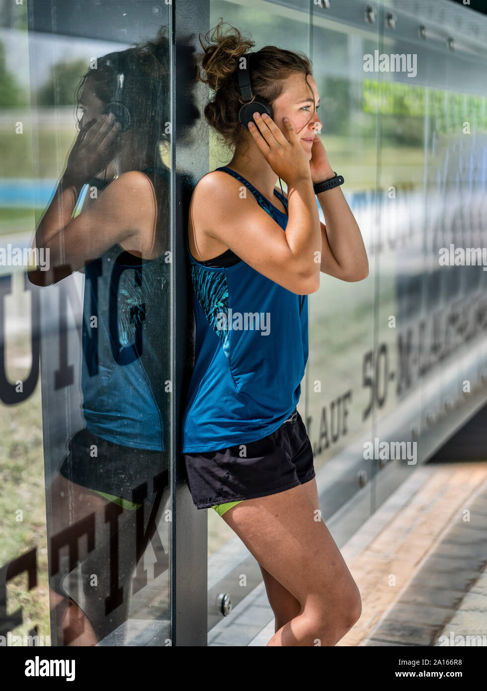 Young sportive woman wearing headphones Stock Photo