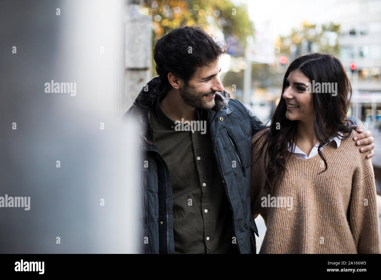 Happy couple in the city looking at each other Stock Photo