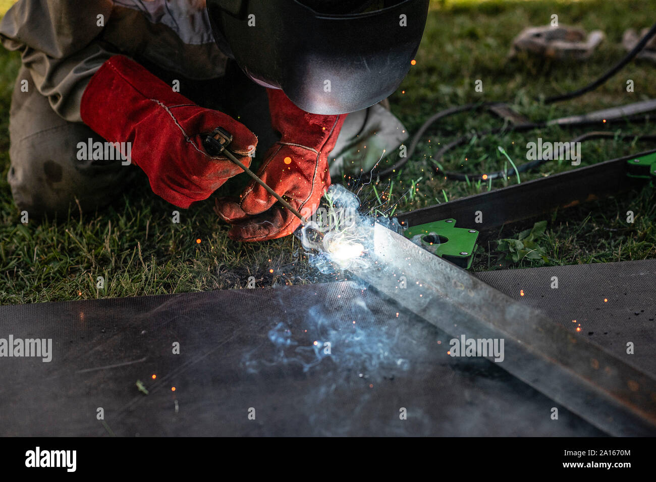 Man welding metal in his backyard Stock Photo