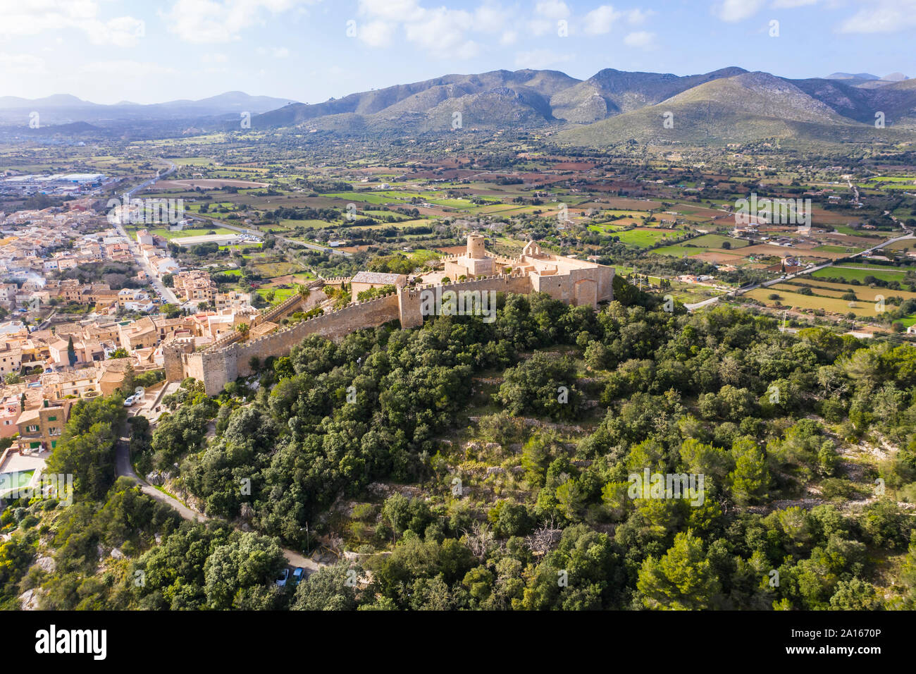Aerial view of Castle Of Capdepera by trees against sky Stock Photo