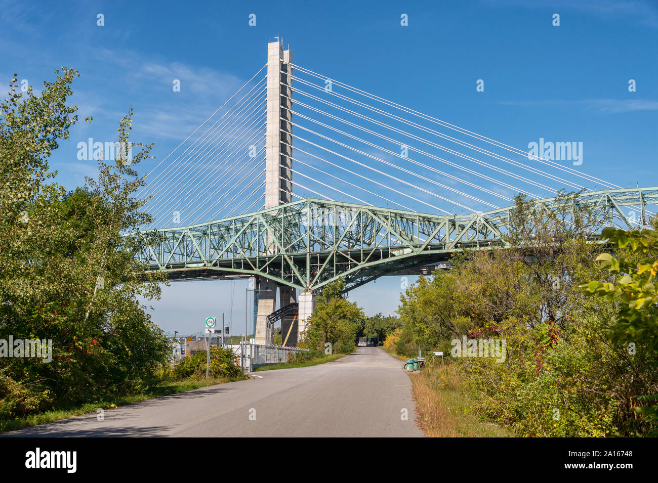 Montreal, Canada - 19 September 2019: New Champlain bridge next to Old Champlain Bridge from Petite Voie du Fleuve. Stock Photo