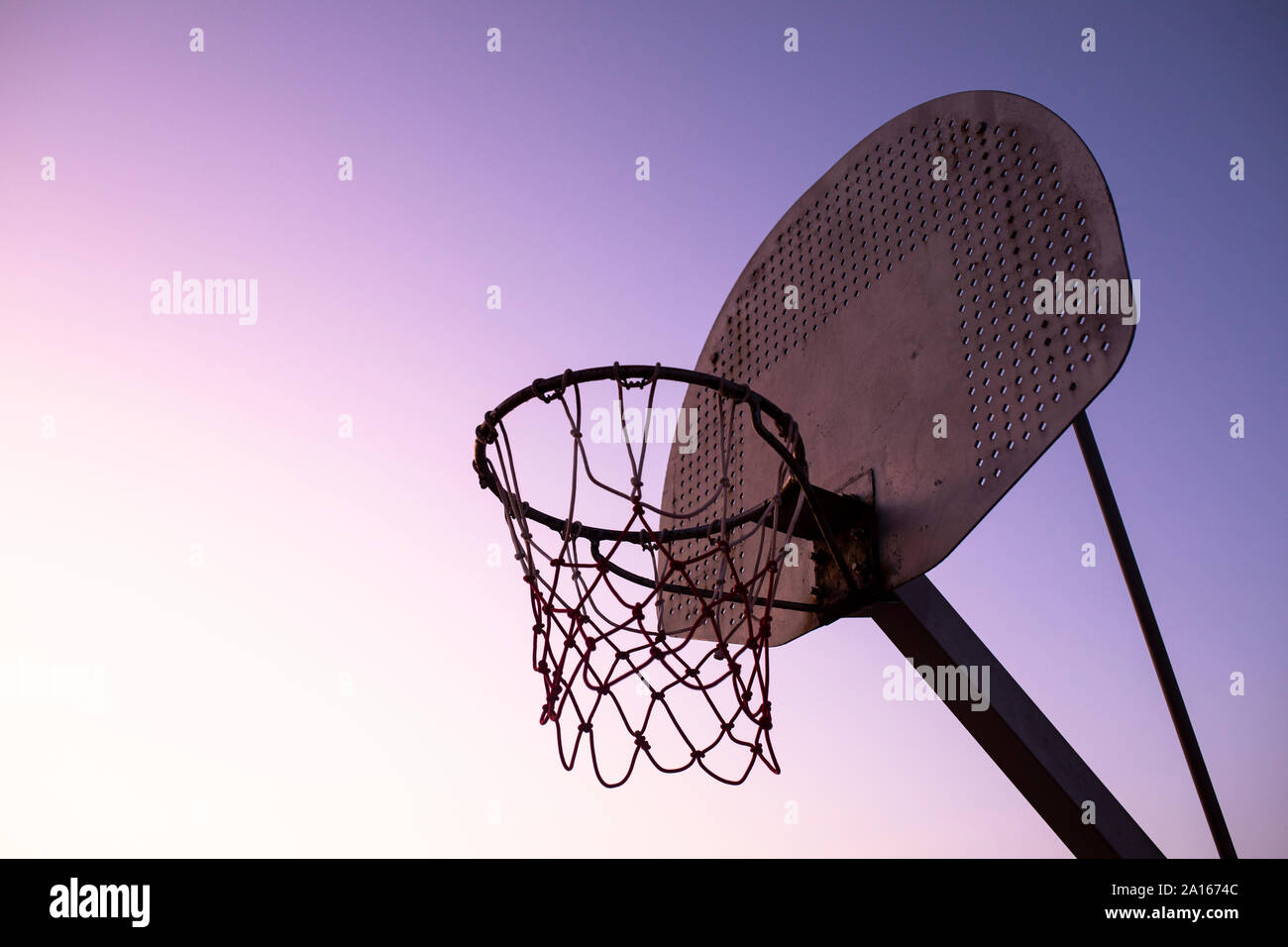 Basketball hoop at sunset Stock Photo