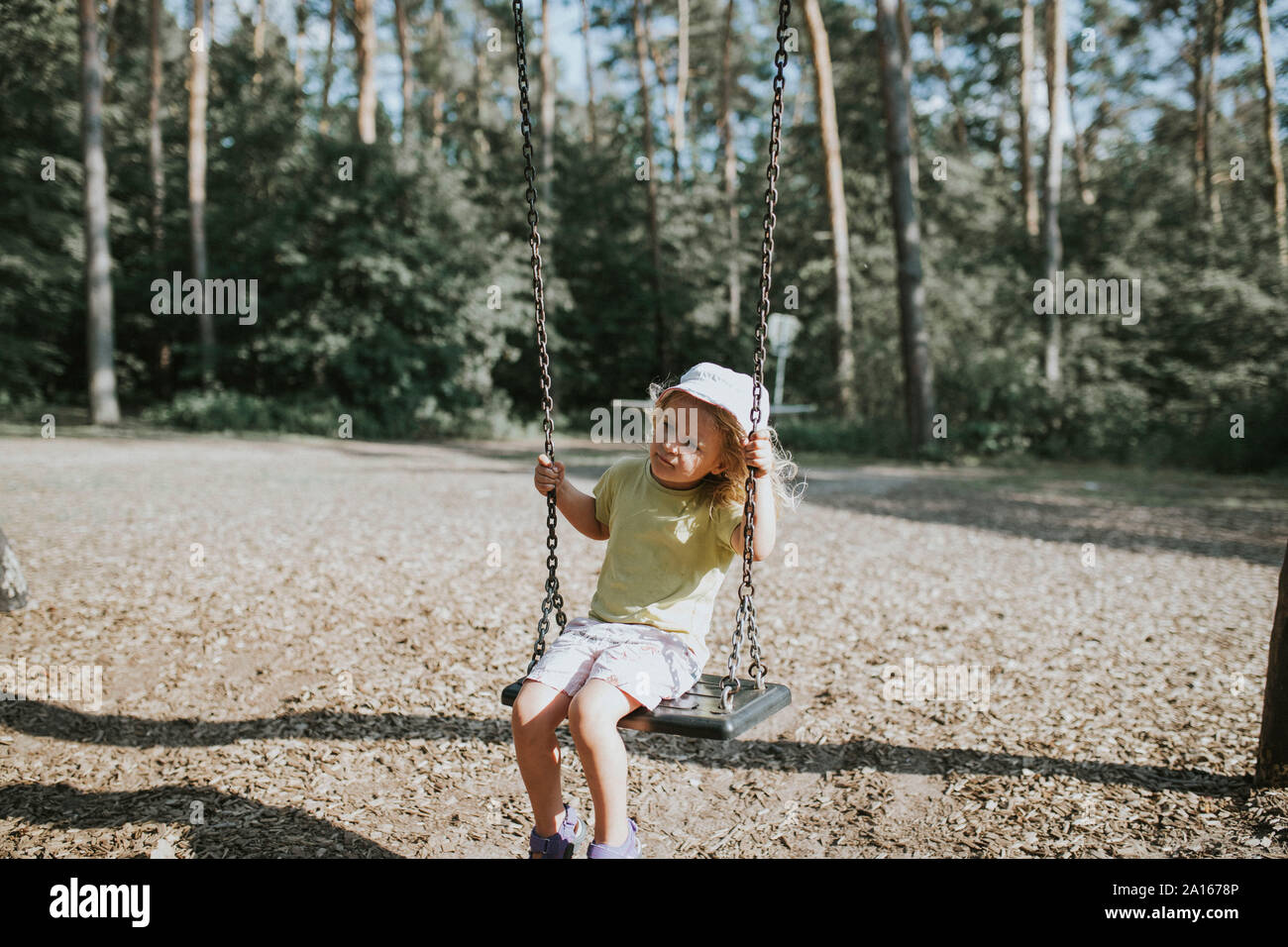 Girl on swing on a playground Stock Photo