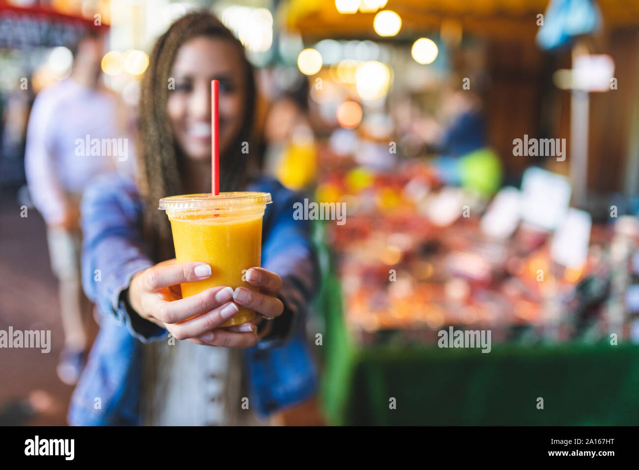 https://c8.alamy.com/comp/2A167HT/womans-hands-holding-plastic-cup-of-fresh-orange-juice-close-up-2A167HT.jpg