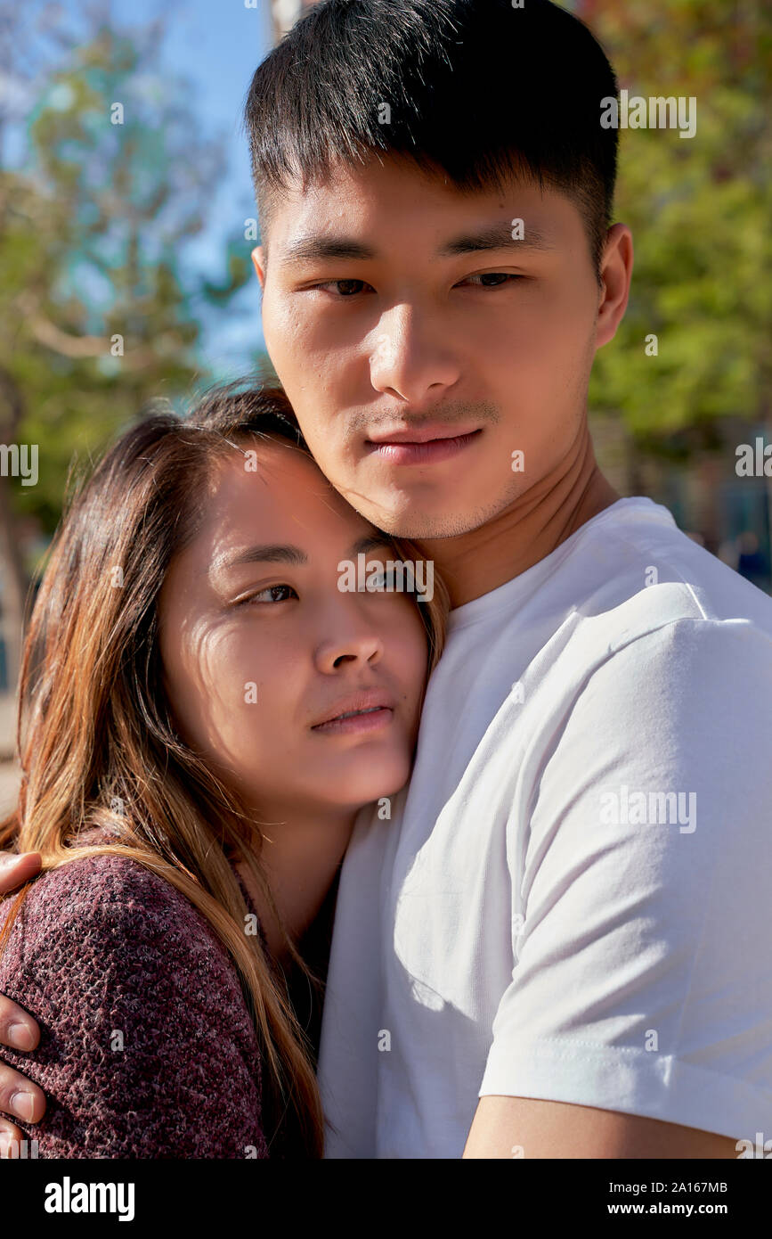 Asian couple hugging outdoors hi-res stock photography and images - Alamy