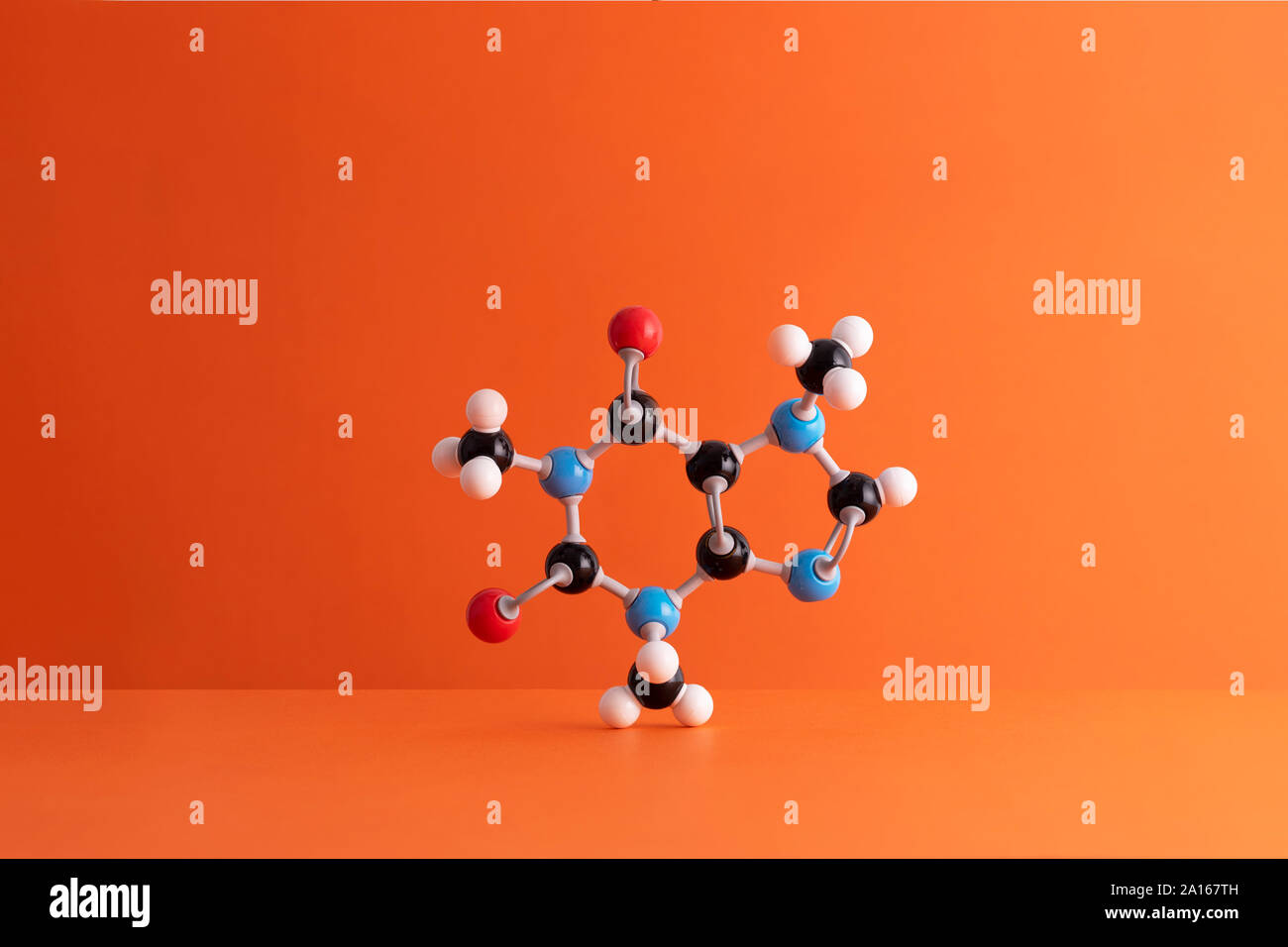 Caffeine formula's molecular structure over orange background Stock Photo