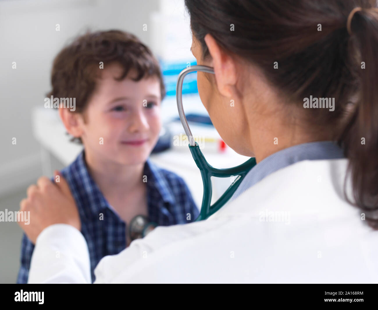 Female doctor examiming a boy in a clinic Stock Photo
