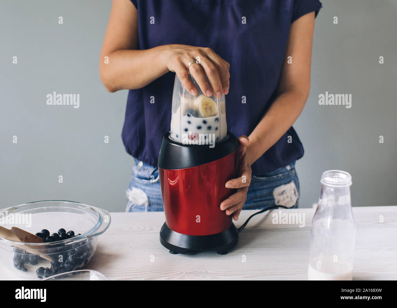 close up of woman hand pouring milk to blender Stock Photo - Alamy