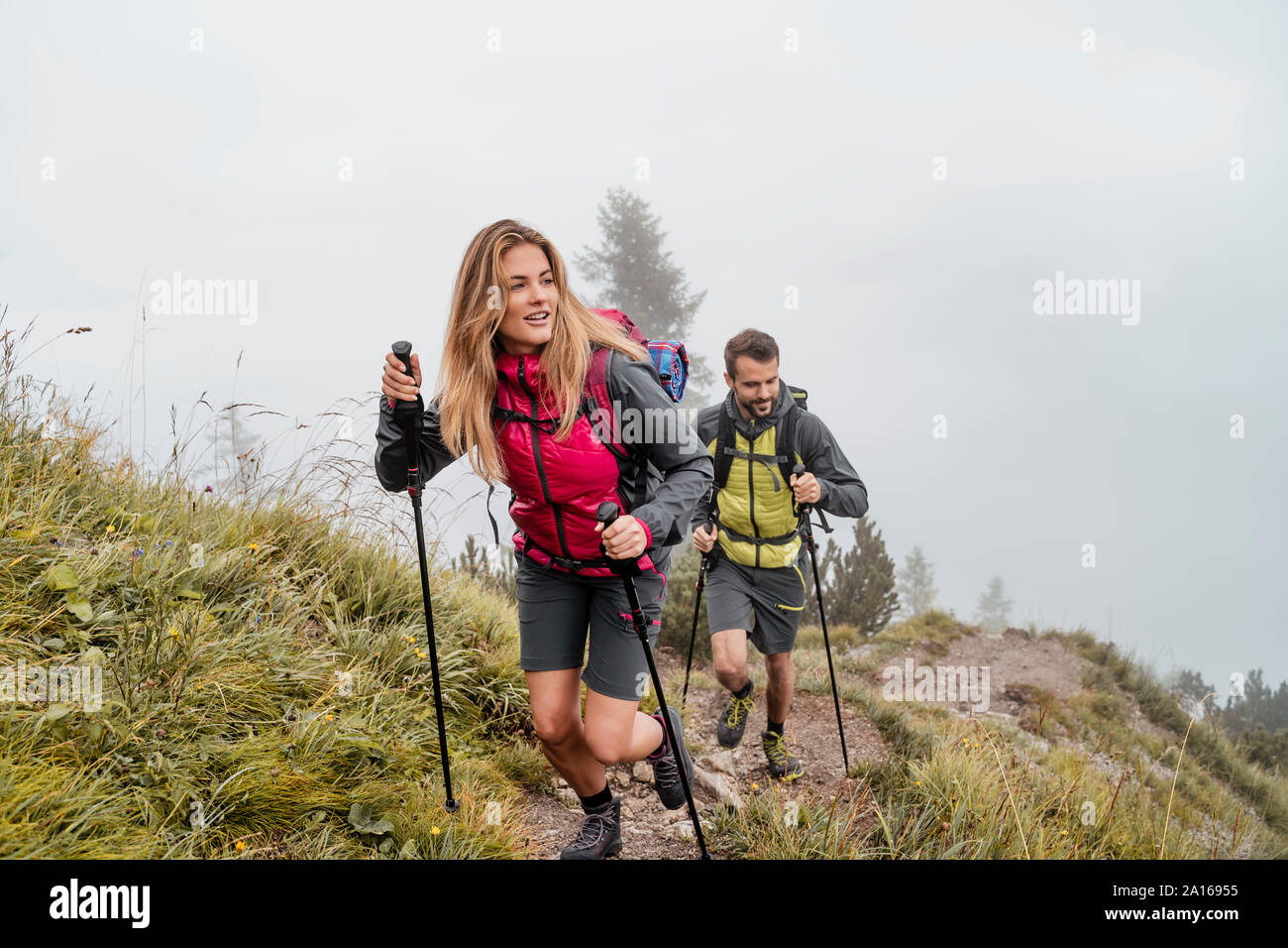 Young couple on a hiking trip in the mountains, Herzogstand, Bavaria, Germany Stock Photo
