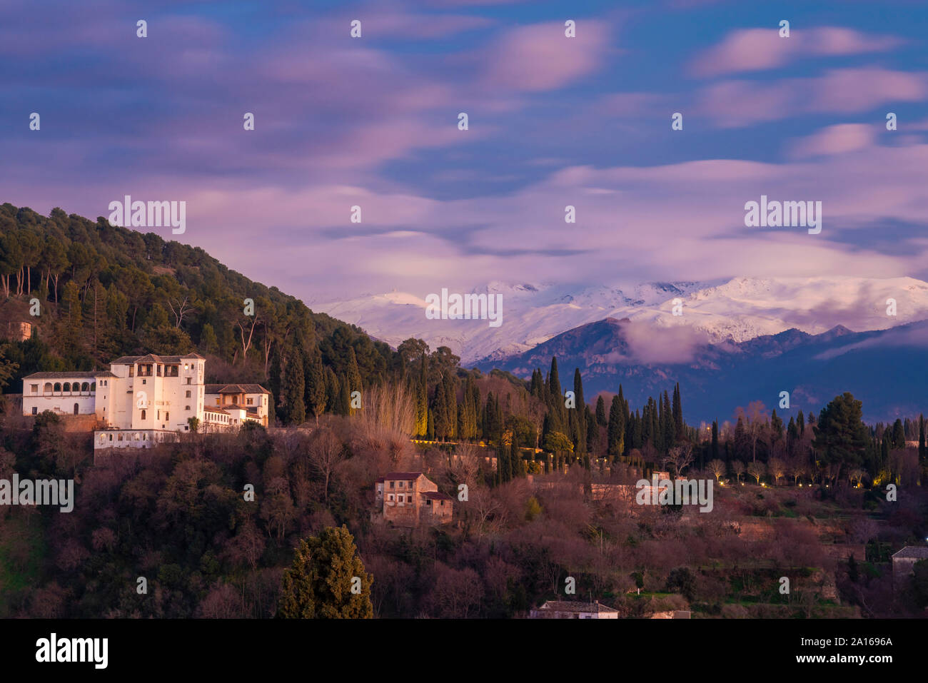 View of Alhambra with Sierra Nevada in the background at sunset, Granada, Spain Stock Photo