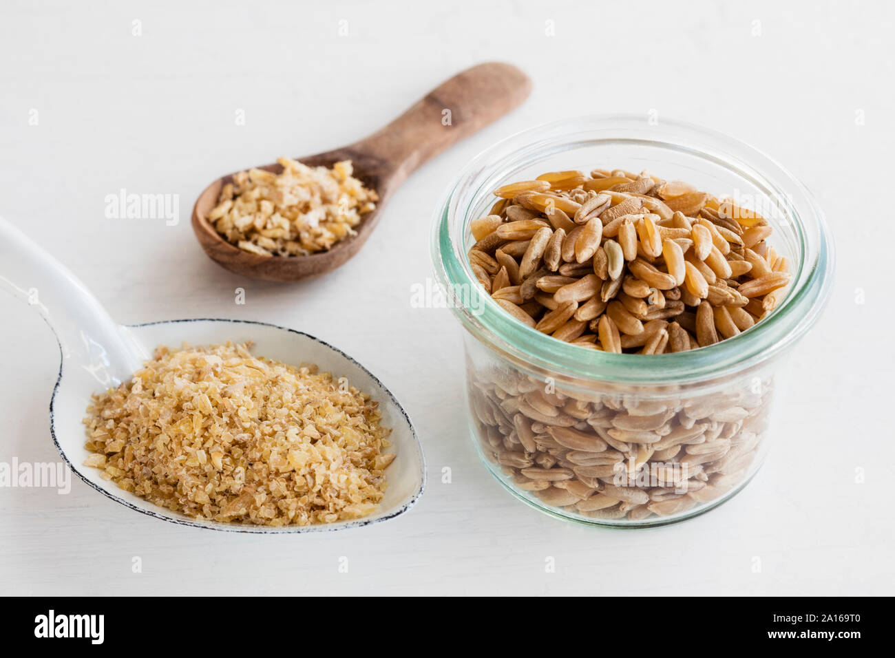 Ancient grains, Polish Wheat in bowl as grain, coarse meal and semolina Stock Photo