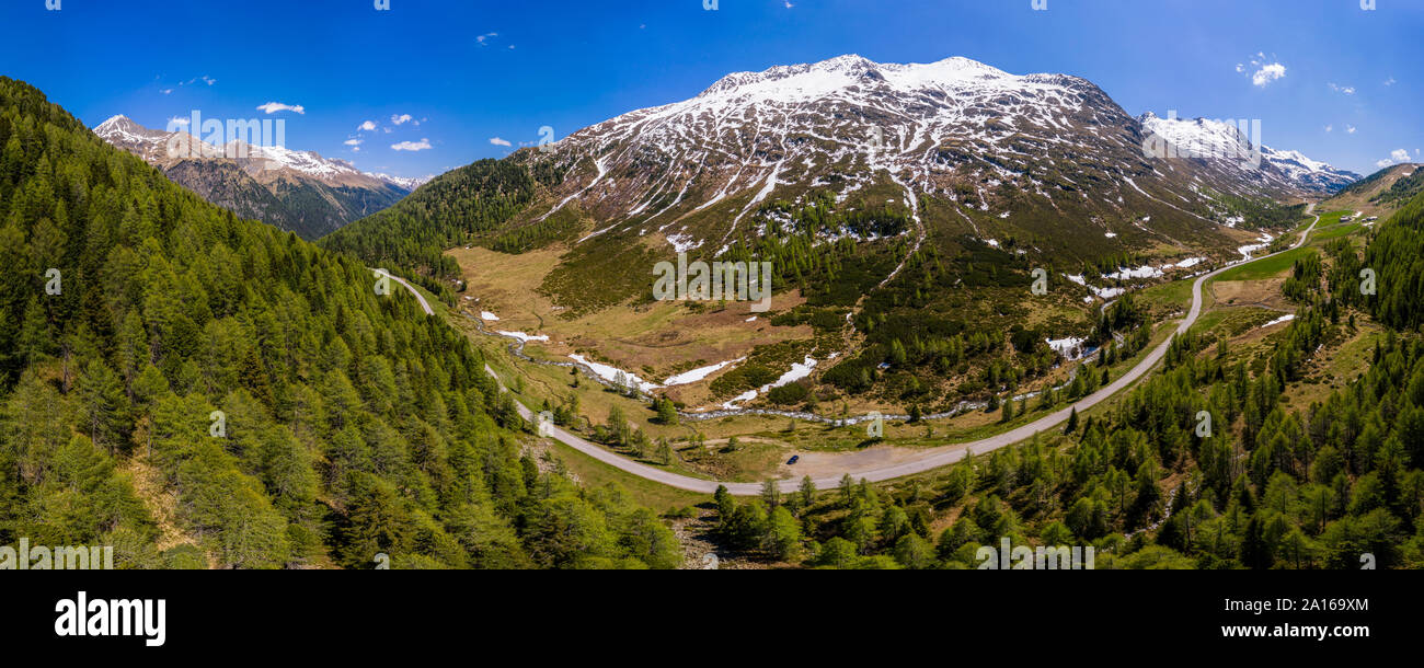 Scenic panorama of winding road across forested landscape of Defereggen Valley, East Tyrol, Austria Stock Photo