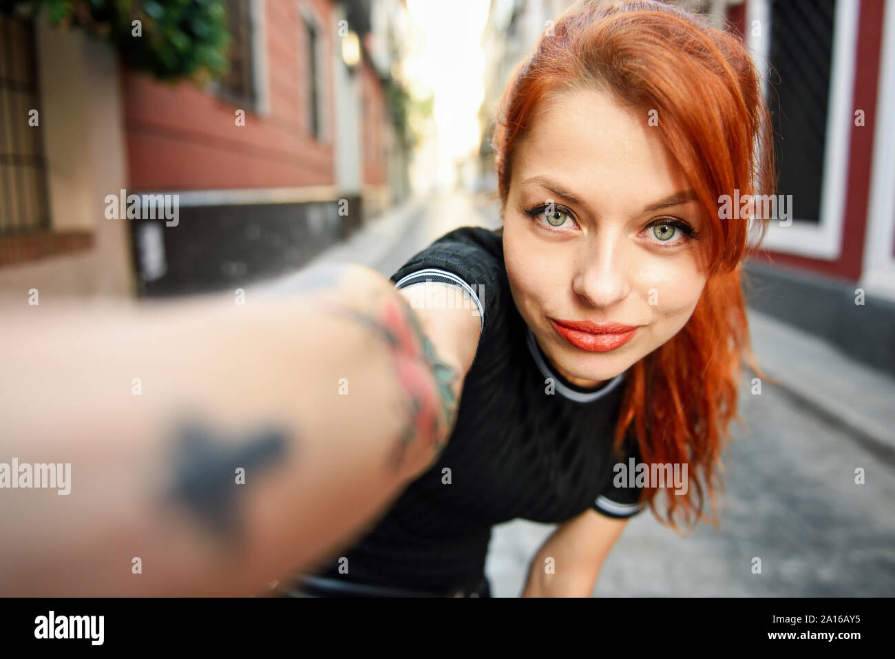 Selfie portrait of red-haired woman in the city Stock Photo