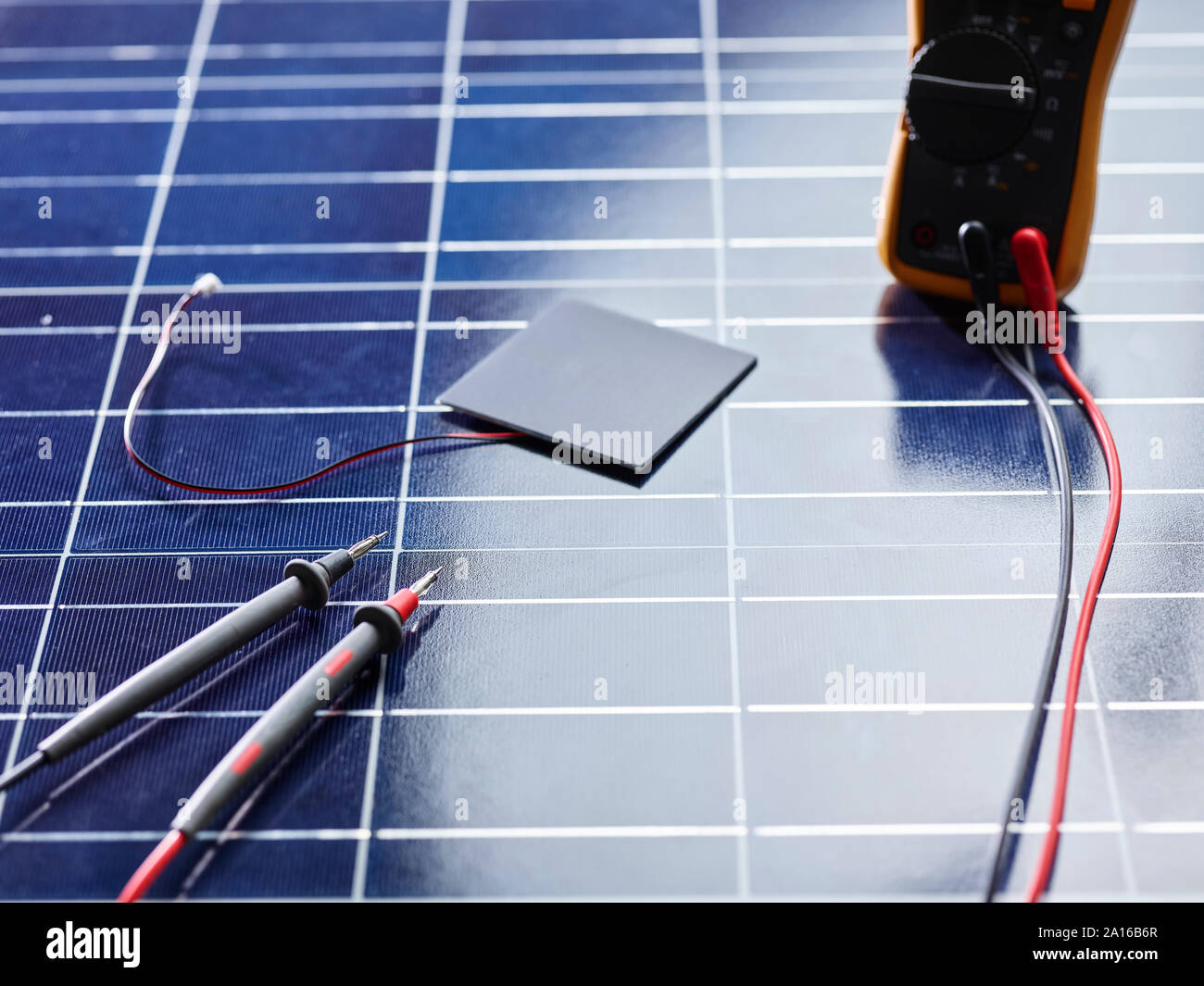 Silicon solar cell with wires on solar panel with measuring device Stock Photo