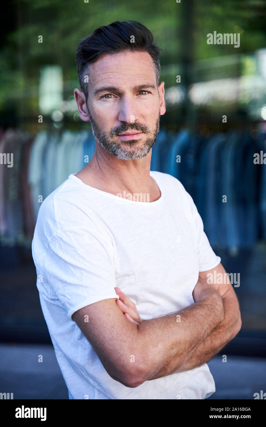 Portrait of mature man with crossed arms Stock Photo - Alamy