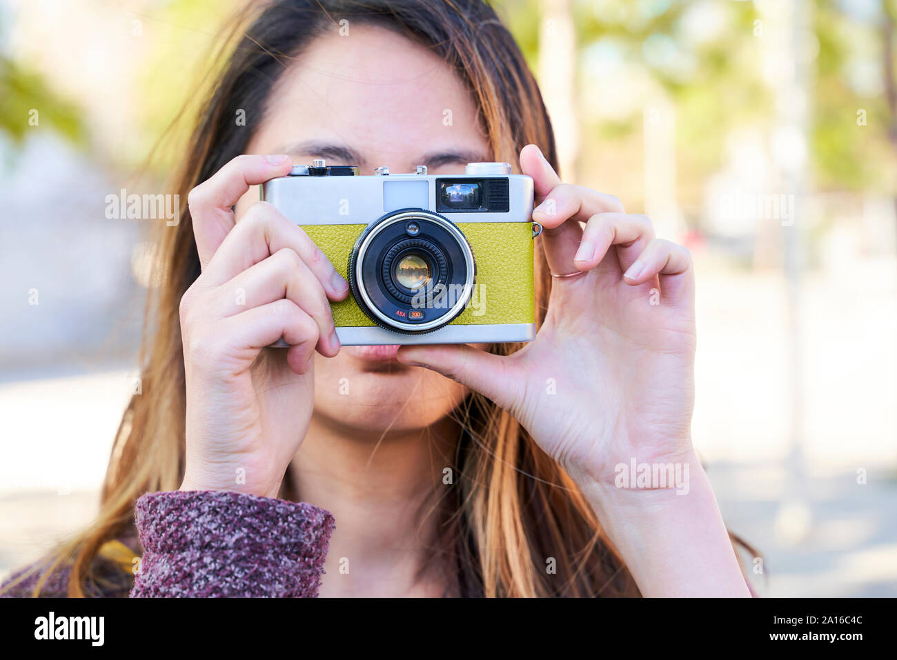 Woman taking photos with a vintage analog camera Stock Photo